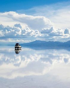 a car is parked in the middle of an empty lake