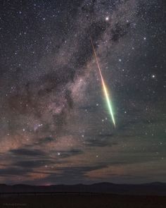 an image of a shooting star in the night sky