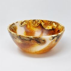 a brown and white bowl sitting on top of a table