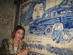 a woman standing in front of a mural on the wall