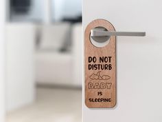 a wooden door handle with a baby is sleeping sign on it that says, don't disturb baby is sleeping