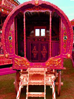 an elaborately decorated horse drawn carriage on display