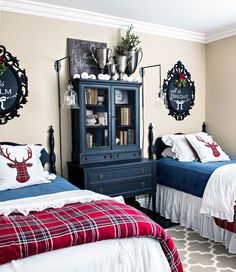 two beds in a room with red, white and blue bedding