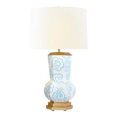 a blue and white lamp on a wooden base with a light shade over the top