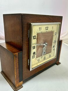 an old wooden clock sitting on top of a table