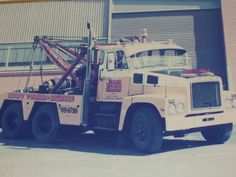 a tow truck parked in front of a building