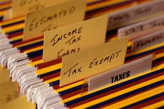 there are many different types of taxes on the table with name tags attached to them