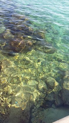 the water is crystal clear and there are rocks in it