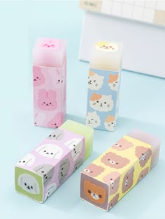 three different colored boxes with animals on them