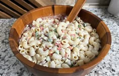 a wooden bowl filled with macaroni and cheese