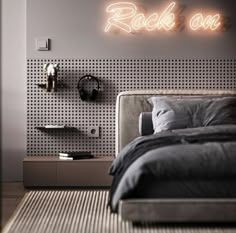 a bed sitting under a neon sign in a bedroom