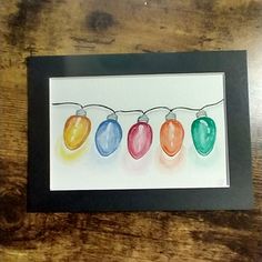 a watercolor painting of christmas lights hanging on a string