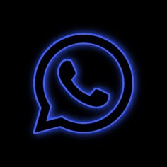 an illuminated blue whatsapp icon on a black background