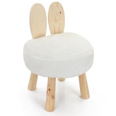 a wooden stool with two white cushions on the seat and one in the shape of an animal's head