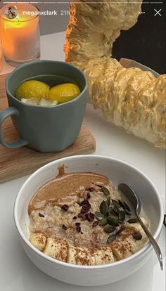 a bowl of oatmeal with lemons and other food on a table