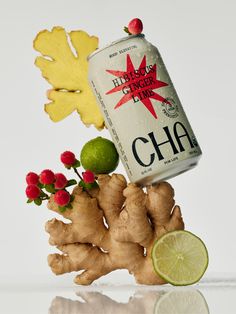 a can of chai with fresh ginger root and lime on the side next to it