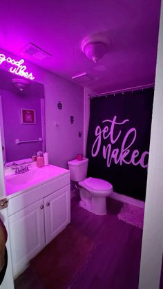 a bathroom with purple lights on the walls