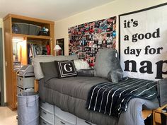 a bedroom with a bed, desk and storage bins on the wall next to it