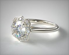 a white gold ring with an oval cut diamond in the center