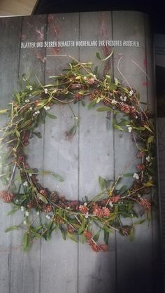 a wreath made out of branches and pine cones