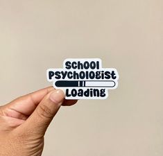 someone holding up a sticker that says school psychologist loading