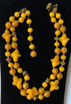 "Here is a beautiful vintage necklace by designer Miriam Haskell. The necklace is artfully crafted with two strands of sumptuous glass beads in rich butterscotch yellow and mustard yellow tones. The glistening beads are in an assortment of interesting shapes and size, with each bead spaced in-between pairs of tiny glinting gold tone seed beads, and at intervals in-between antiqued gold tone ribbed spacer beads. The necklace has a gilt filigree hook and an adjustable extension strand for closure. Miriam Haskell Necklace, Interesting Shapes, Miriam Haskell Jewelry, Yellow Necklace, Vintage Necklaces, Miriam Haskell, Yellow Tones, Red Rhinestone, Crystal Pearls