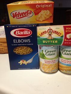 three boxes of cereal sitting on top of a counter