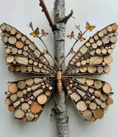 a butterfly made out of wood sitting on top of a tree