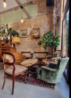 a living room filled with furniture next to a window covered in plants and potted plants