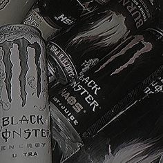 two cans of monster energy drink sitting next to each other