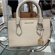 **New** $498 Michael Kors Sheila Small Vegan Saffiano Crossbody Satchel Bag Purse! - Color: Light Cream - Crossbody Bag - Faux Saffiano Non-Leather - Gold Toned Hardware - 1 Mk Charm - Zip Top Closure - Triple Compartment With Center Zip - Custom Fabric Lining - 1 Slip-In Pocket - 9" (L) X 6.5"(H) X 3"(D) - Straps: 3.5" - Adjustable Crossbody Strap: 20.25"-23.75" - Dust Bag Not Included Feel Free To Message Me With Any Questions! Bundle Up To Save!!! Check Out My Closet For More Items! Mini Hand Bag, Michael Kors Satchel, Michael Kors Logo, Crossbody Satchel, Mk Bags, Fancy Bags, Pretty Bags, Cute Purses, Crocodile Leather