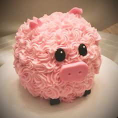 a cake shaped like a pig with pink icing on it's face and eyes