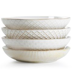 four white bowls stacked on top of each other