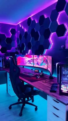 an office with purple lighting and hexagonal mirrors on the wall, along with a computer desk