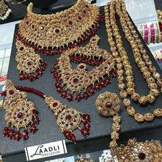 an assortment of necklaces and bracelets on display at a jewelery shop in india