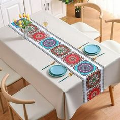 the table is set with plates and place mats for two people to sit down at