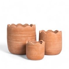 three clay pots sitting next to each other