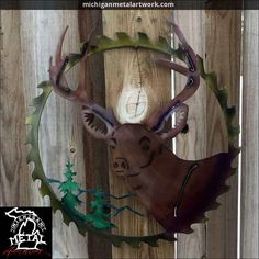 a deer head mounted to the side of a wooden fence