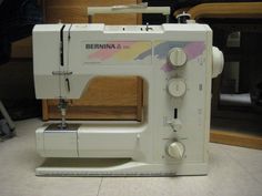 a white sewing machine sitting on top of a counter