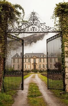 an iron gate leading to a large house