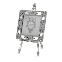 an ornate silver frame with diamonds on it