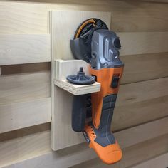 a cordless driller is mounted on the wall with a tool holder attached to it