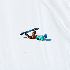 a snowboarder falling off his board in the air