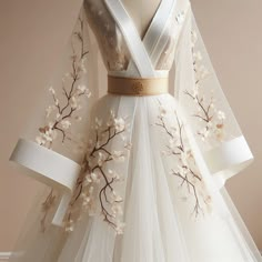 a white wedding dress with flowers on it