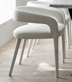 a row of white chairs sitting next to each other