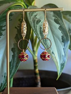 "Redesigned vintage red crystal & gold dangly earrings. Gorgeous dark red crystals with gold details.  Originally clip-on earrings, this set has been repurposed & recreated into a fun new style for pierced ears. New hardware, new bits & pieces, new look. *Note: as parts of the earrings are sourced from vintage materials there is some slight wear, but that's what makes them special (: No two sets of earrings will be the same.  ------ Hooks shown are 14k gold-plated fish hook-style hooks, but can Dark Red Crystals, Dangly Earrings, Red Crystals, Pierced Ears, Fish Hook, Gold Details, New Style, Dark Red, Long Tops