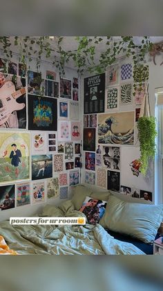 a bed with lots of pictures on the wall above it and a plant hanging from the ceiling