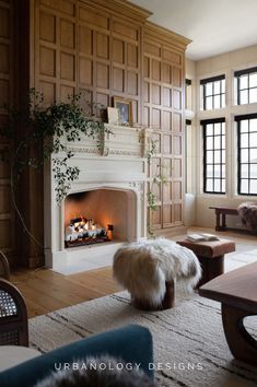 This warm, inviting lakehouse living room by Urbanology Designs blends classic architectural details with organic textures for a modern rustic retreat. The grand stone fireplace anchors the space, surrounded by rich wood paneling, plush furnishings, and layered textiles that create a cozy, intimate ambiance. Thoughtful design choices bring effortless luxury and comfort to this Texas lakehouse for influencer Lauren Kay Sims. Urbanology Designs offers interior design services nationwide.