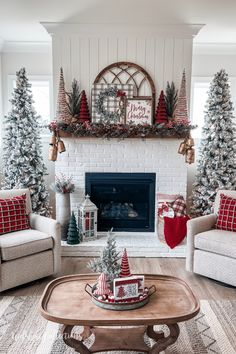 a living room decorated for christmas with red and white decor