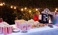 an outdoor movie party with popcorn and snacks